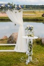 The wedding arch is decorated with blue flowers and white light silk. Summer Wedding Ceremony Royalty Free Stock Photo