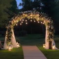 Wedding arch decorated with flowers and lanterns at night.