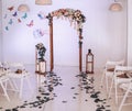 Wedding arch decorated with flowers. Large candlesticks with candles in the room with decor. Wedding ceremony Royalty Free Stock Photo