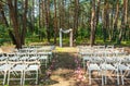 Wedding arch decorated with flowers outdoors. Beautiful wedding set up.