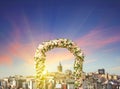 Wedding arch decorated with flowers of roses with Galata tower at sunset