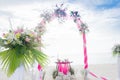 Wedding arch decorated with flowers on tropical beach, outd