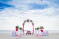 Wedding arch decorated with flowers on tropical beach, outd