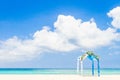 Wedding arch decorated with flowers on tropical beach, outd