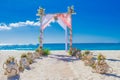 Wedding arch decorated with flowers on tropical beach, outd