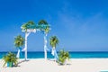 Wedding arch decorated with flowers on tropical beach, outd