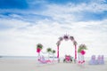 wedding arch decorated with flowers on tropical sand beach, outdoor beach wedding setup Royalty Free Stock Photo