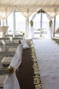 Wedding arch decorated with flowers. White carpet in the restaurant Royalty Free Stock Photo