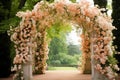wedding arch decorated with pink and white flowers in the park