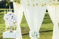 Wedding arch with flowers and ÃÂandle decoration on sunny day in ceremony place Royalty Free Stock Photo