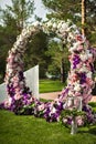 Wedding arch of flowers with torches at an outdoor ceremony