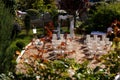 Wedding arch with flowers in the yard.white chairs on side Royalty Free Stock Photo