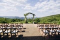 Wedding arch on rustuc style with white flowers in park with light bulbs.