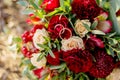 Wedding background bouquet and rings.The bride`s bouquet of red and pink flowers and greenery, with color Marsala. declaration o Royalty Free Stock Photo