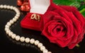 Wedding background .Rose , pearls and a gold ring