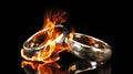 Wedding band rings on fire symbolizing broken marriage, divorce, infidelity, cheating