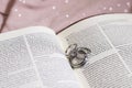 Wedding Bands Engagement Ring on Bible New Testament Pages Royalty Free Stock Photo