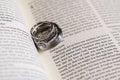 Wedding Bands Engagement Ring on Bible New Testament Pages Royalty Free Stock Photo
