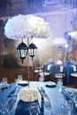 Wedding. Banquet. The chairs and round table for guests, served with cutlery and crockery and covered with a blue Royalty Free Stock Photo