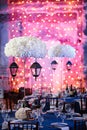 Wedding. Banquet. The chairs and round table for guests, served with cutlery and crockery and covered with a blue Royalty Free Stock Photo