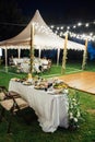 Wedding. Banquet. The chairs and round table for guests, served with cutlery. Evening time Royalty Free Stock Photo