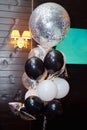 Wedding or birthday photo zone with white, black and silver balloons indoors, copy space.