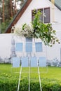 Wedding board, mockup, invitation easel, with space for an inscription, decorated with fresh flowers. Festive decor, copy space.