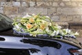 Wedding bouquet on the black car.