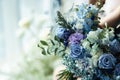 Wedding bouquet of blue and purple flowers.