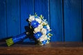 Wedding bouquet with blue and white flowers on a blue background Royalty Free Stock Photo