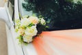 Wedding bouquet bridal decoration on luxury white car. Royalty Free Stock Photo