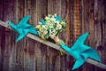 Wedding bouquet of the bride on a beautiful wooden background with paper turntables