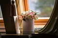 Wedding bouquet of bride in a hatbox on the window