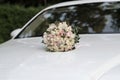 Wedding bouquet of the bride on the hood of the car Royalty Free Stock Photo