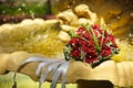 The Wedding Bouquet Of The Bride Of Red Roses Lies In An Old Fountain Under Splashes And Drops Of Water. Royalty Free Stock Photo