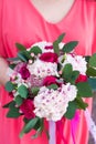 the bride holds a beautiful wedding bouquet