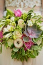 Wedding bouquet in the bride`s hands, succulents