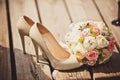 Wedding bouquet and bride shoes Royalty Free Stock Photo