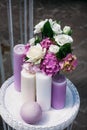 Wedding bouquet for the bride of white and yellow roses and other flowers, multi-colored candles Royalty Free Stock Photo