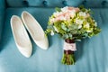 Wedding bouquet and bridesmaid shoes on blue mat Royalty Free Stock Photo