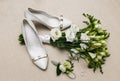 Wedding bouquet and bridesmaid shoes, boutonniere, and ring. Royalty Free Stock Photo