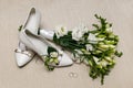 Wedding bouquet and bridesmaid shoes, boutonniere, and ring. Royalty Free Stock Photo