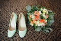 Wedding bouquet and bridesmaid shoes on brown mat Royalty Free Stock Photo