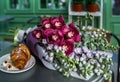 Wedding bouquet with dessert lying on wooden table in bride room