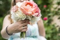 Wedding bouquet of flowers held by bride closeup. Pink flower showing ring Royalty Free Stock Photo