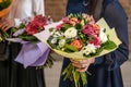 Wedding bouquet of flowers held by bride closeup. Pink and yellow roses flowers Royalty Free Stock Photo