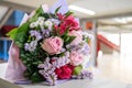 Wedding bouquet of flowers held by bride closeup. Pink and yellow roses flowers Royalty Free Stock Photo