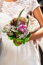 Wedding bouquet of flowers held by a bride. Pink, yellow and Green Royalty Free Stock Photo