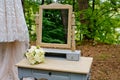 A wedding bouquet in the forest on a table with a mirror. Royalty Free Stock Photo