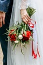 Wedding bouquet of fresh flowers in bride`s hands, close-up. Young bride holding a bouquet of white and red flowers Royalty Free Stock Photo